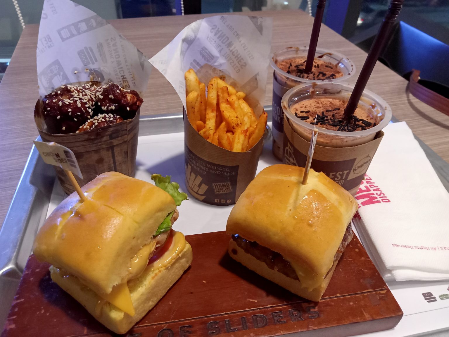 Quick-service meal with burgers, wings, fries and drinks